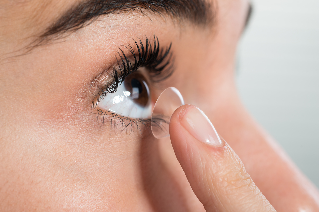 A person putting a contact lens on her eye, Proper Contact Lens Care: Everything You Need to Know