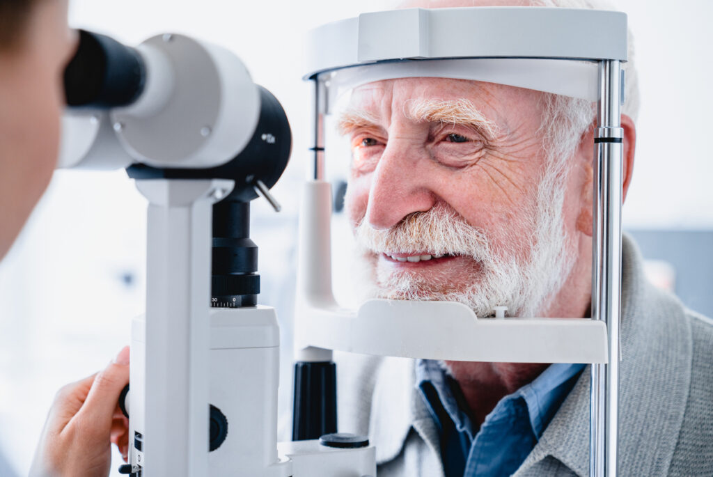 Close up photo of smiling senior male patient during sight examination, Senior Eye Health