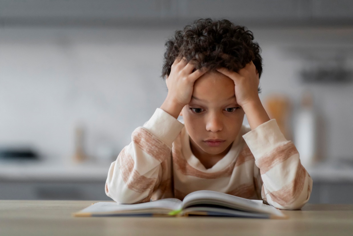 Annual eye exams for children, A kid struggling to read a book