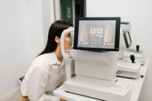 How AI Is Revolutionizing Eye Care (And Why Personal Care Still Matters More Than Ever), Patient undergoing digital retinal imaging with a modern eye care device, showing advanced diagnostic technology used in routine eye exams.