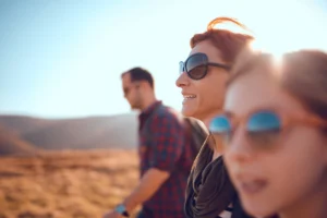 People wearing sunglasses outdoors in bright sunlight to protect their eyes from UV exposure”
