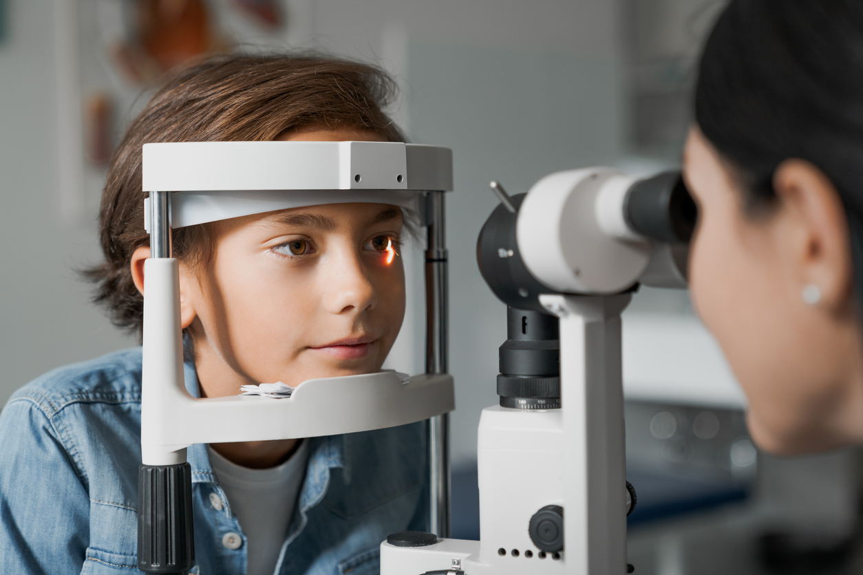Young child receiving a comprehensive eye exam to evaluate vision and eye health.